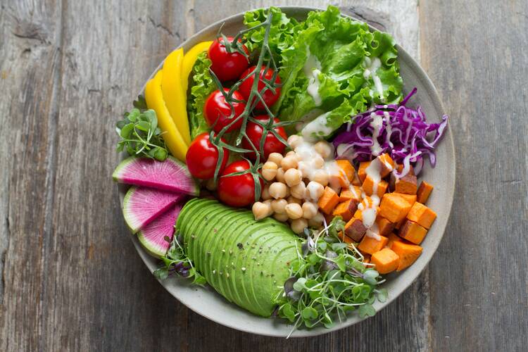 A colorful array of fresh fruits and vegetables on a platter.