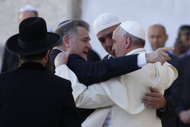 Pope Francis embraces Argentine Rabbi Abraham Skorka and Omar Abboud after praying at the Western Wall in Jerusalem on May 26, 2014. (CNS photo/Paul Haring)