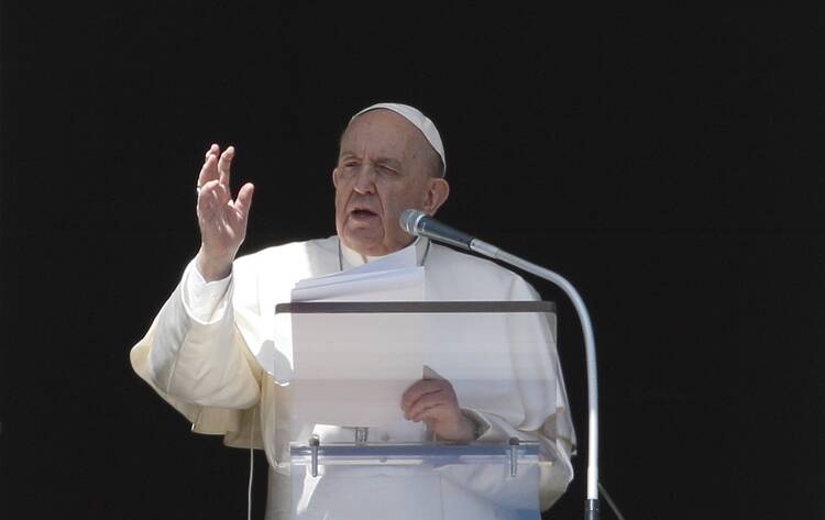 Pope Francis gives his blessing after leading the Angelus from the window of his studio overlooking St. Peter's Square at the Vatican March 13, 2022.