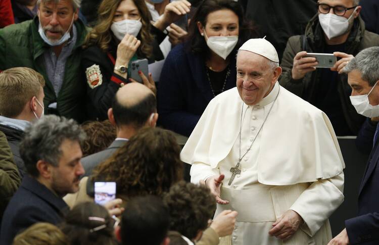 Pope Francis greets people during his general audience in the Paul VI hall at the Vatican March 16, 2022.