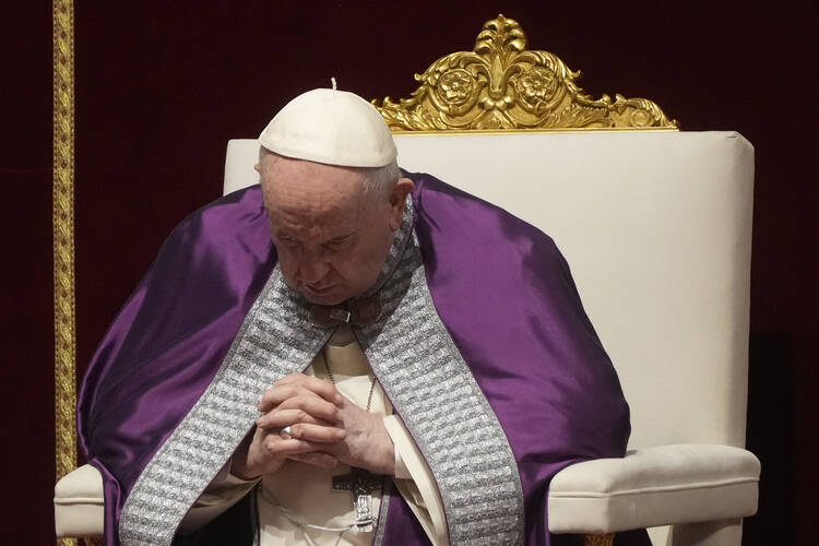 Pope Francis prays during a special prayer in St. Peter's Basilica at the Vatican, Friday, March 25, 2022, wearing purple vestments.