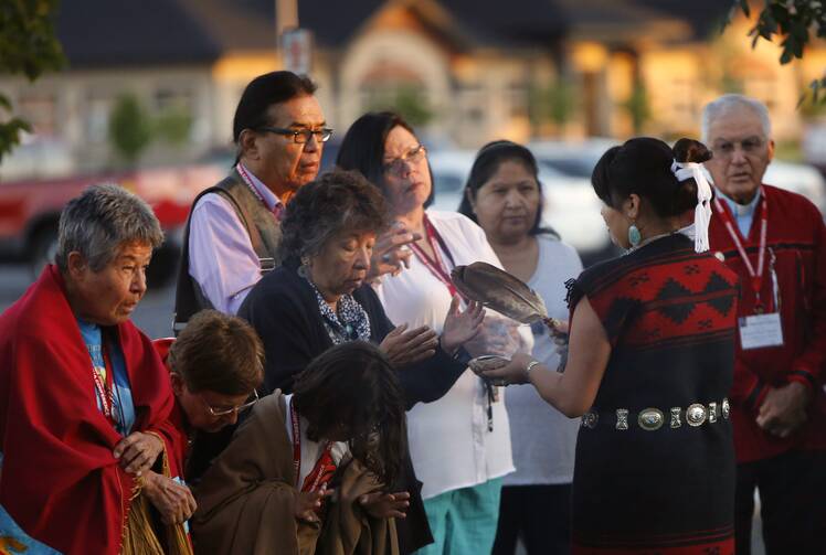 A sunrise ceremony, including the Native American purification ritual called smudging, at the Tekakwitha Conference in Fargo, N.D., on July 26, 2014. The conference was named for St. Kateri Tekakwitha, the first Native American to be canonized in the Catholic Church. (CNS photo/Nancy Wiechec)