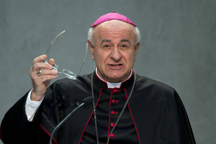 Archbishop Vincenzo Paglia during a news conference at the Vatican on Feb. 4, 2015, holding his glasses in hand.