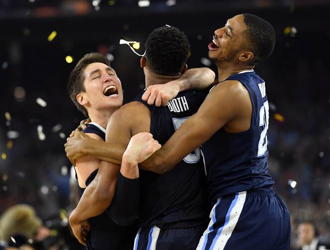 Villanova Wildcats players Ryan Arcidiacono, left, Phil Booth (5) and guard Mikal Bridges (25) celebrate after the team’s championship win of the 2016 NCAA Men's Final Four in Houston.