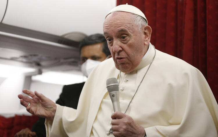 Pope Francis answers questions from journalists aboard his flight from Malta to Rome April 3, 2022. (CNS photo/Paul Haring)