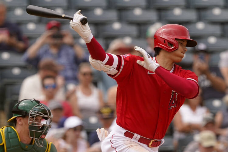 Shohei Ohtani of the Los Angeles Angels strikes out against the Oakland Athletics during a spring training game on March 28, 2022, in Tempe, Ariz. (AP Photo/Matt York)