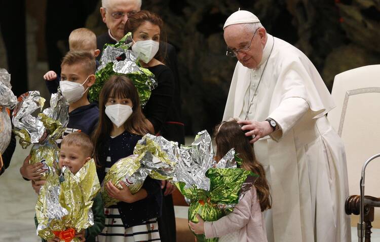 Pope Francis greets Ukrainian refugees during his general audience in the Paul VI hall at the Vatican April 6, 2022.