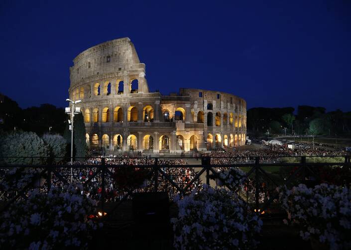 People gather outside Rome's Colosseum April 19, 2019, before Pope Francis leads the Way of the Cross.