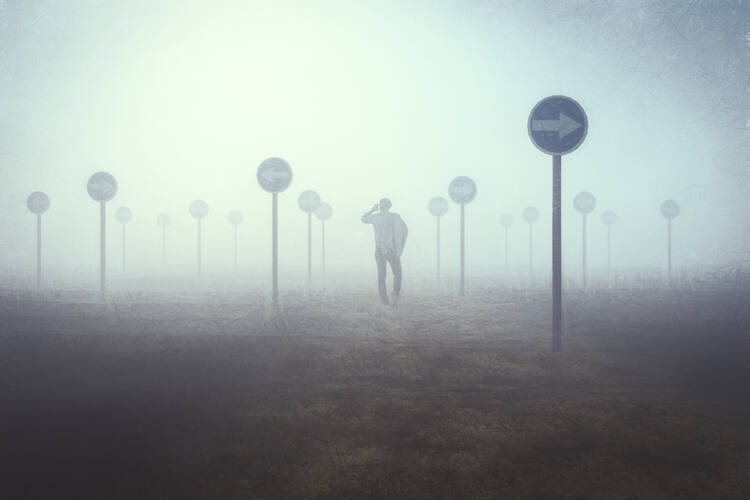 Stock image of a man in the midst of fog navigating a road filled with “do not enter” signs.