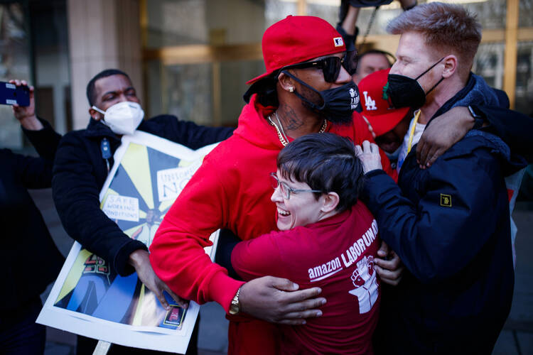 Chris Smalls, wearing baseball cap, celebrates with union members after getting the voting results to unionize workers at the Amazon warehouse on Staten Island, N.Y., on April 1, 2022. (AP Photo/Eduardo Munoz Alvarez, File)