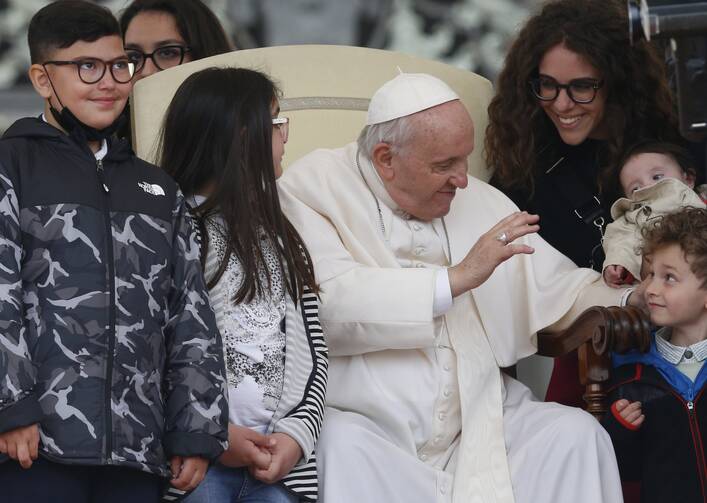 Pope Francis greets children during his general audience in St. Peter’s Square at the Vatican May 4, 2022.