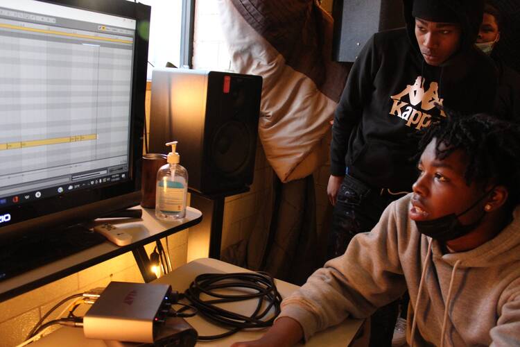 Young men engaged in an art lab at Precious Blood Ministry of Reconciliation. Photo courtesy of PBMR.