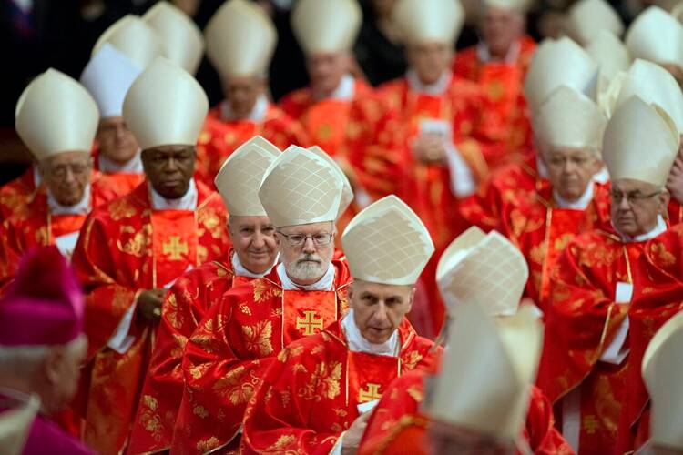 Cardinals in scarlet vestments leave the Pro Eligendo Pontiface Mass prior to the Conclave, March 12, 2013, at the Vatican.