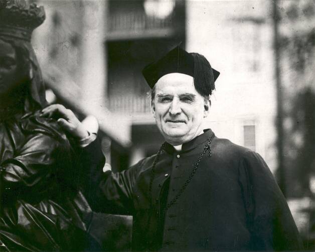 A black-and-white photo of Msgr. Nelson Baker wearing a biretta.