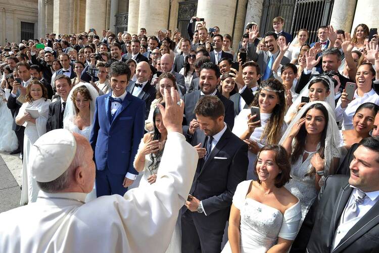 Pope Francis greets newly married couples during his general audience in St. Peter’s Square at the Vatican on Sept. 30, 2015.