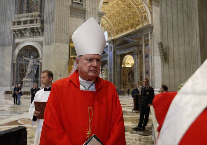 Bishop Robert J. McManus in red vestments and a miter at St. Peter’s Basilica.