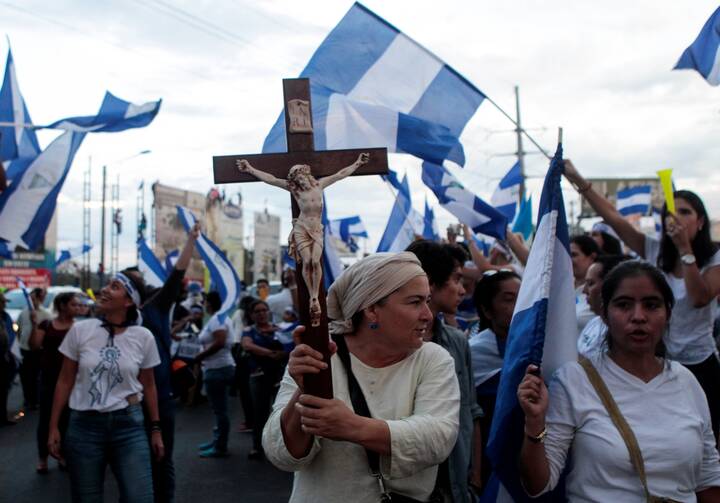 A demonstrator holds a crucifix during a protest against Nicaraguan President Daniel Ortega's government in Managua May 15, 2018. (CNS photo/Oswaldo Rivas, Reuters)