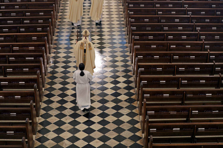 FILE - Archbishop Gregory Aymond conducts the procession to lead a live streamed Easter Mass in St. Louis Cathedral in New Orleans, Sunday, April 12, 2020. The FBI has opened a widening investigation into Roman Catholic sex abuse in New Orleans, looking specifically at whether priests took children across state lines to molest them. The FBI declined to comment, as did the Louisiana State Police, which is assisting in the inquiry. The Archdiocese of New Orleans declined to discuss the federal investigation. 