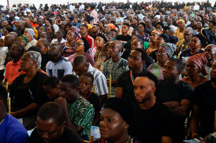 Hundreds attend a funeral Mass in the the parish hall of St. Francis Xavier Church in Owo, Nigeria, June 17, 2022. The Mass was for at least 50 victims killed in a June 5 attack by gunmen during Mass at the church. (CNS photo/Temilade Adelaja, Reuters)