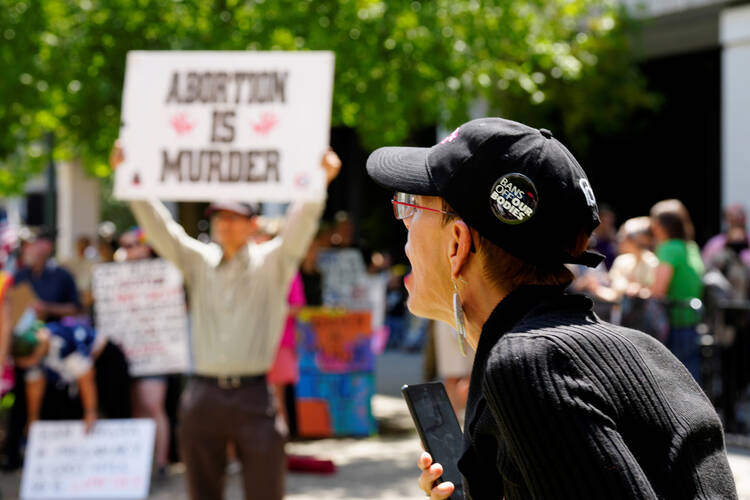 A woman supporting abortion rights shouts at anti-abortion protesters outside the South Carolina Statehouse on July 7, 2022, in Columbia, S.C. (AP Photo/Meg Kinnard)
