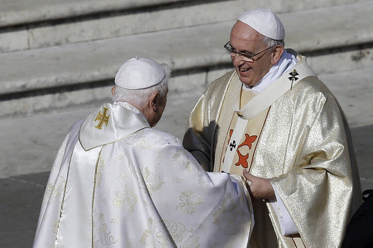 Pope Emeritus Benedict XVI, left, greets Pope Francis prior to the start of the beatification ceremony of Pope Paul VI and a mass for the closing of a two-week synod on family issues, in St. Peter's Square at the Vatican, Sunday, Oct. 19, 2014. Pope Francis has said that if and when he ever retires, he wouldn’t live in the Vatican or return to his native Argentina but would like to find a church in Rome where he could continue hearing confessions. (AP Photo/Gregorio Borgia, File)
