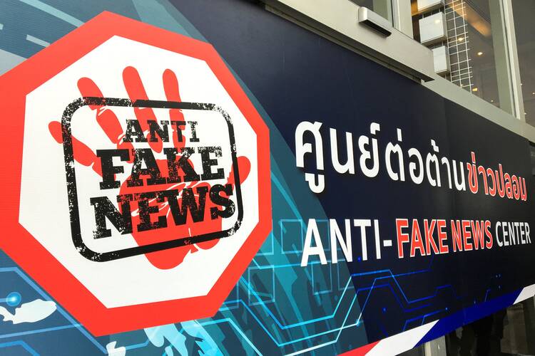 The sign of the Anti-Fake News center is pictured in Bangkok, Thailand, in this Nov. 1, 2019 photo. Pope Francis asked members of Signis, a Catholic communicators association, to educate young people and help them understand how social media "become places of toxicity, hate speech and fake news." (CNS photo/Patpicha Tanakasempipat, Reuters)