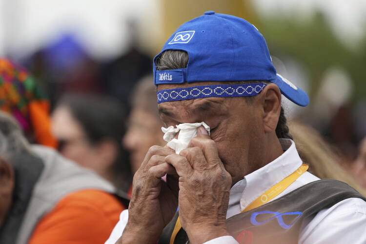 A man wipes his face with a tissue