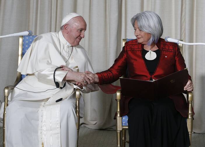The pope shakes hands with Mary Simon, the governor general of Canada