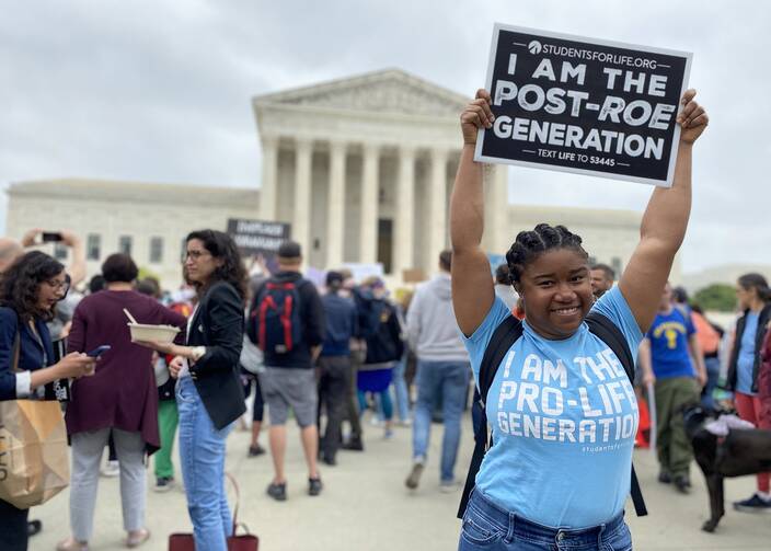 Norvilia Etienne, of Students for Life, holds a sign outside the Supreme Court of the United States on May 3, 2022, the day after a draft of the court's opinion was leaked signaling that the court was leaning toward overturning Roe v. Wade. (CNS photo/Rhina Guidos)