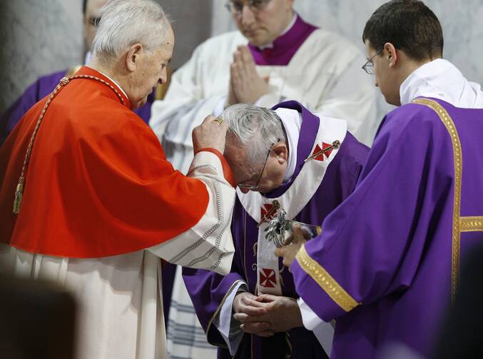 Pope Francis receives ashes from Slovak Cardinal Jozef Tomko during Ash Wednesday Mass at the Basilica of Santa Sabina in Rome March 5, 2014. Cardinal Tomko, the oldest member of the College of Cardinals, died in Rome Aug. 8, 2022, at the age of 98. (CNS photo/Paul Haring)