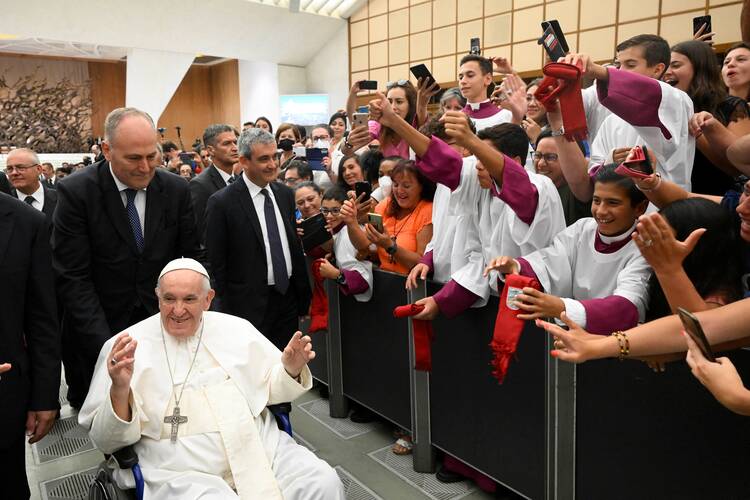 Pope Francis greets people as he arrives for his general audience in the Paul VI hall at the Vatican Aug. 10, 2022. (CNS photo/Vatican Media via Reuters)