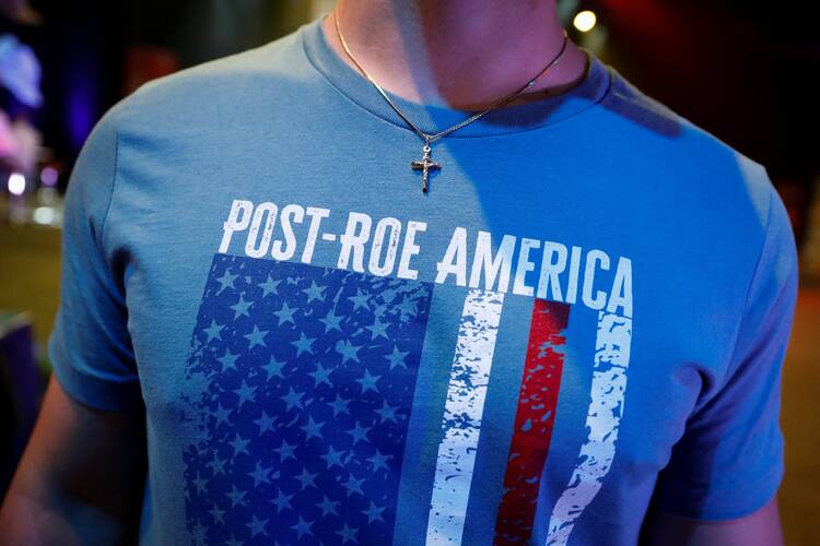 A student wears a crucifix and a pro-life T-shirt during a July 22, 2022, Turning Point USA Student Action Summit (SAS) in Tampa, Fla. (CNS photo/Marco Bello, Reuters)