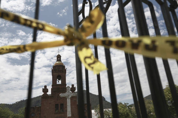 looking at a churched through gates with caution tape tied around them