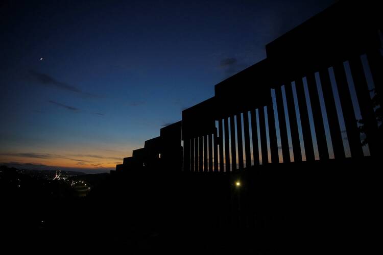 for an article on immigration and migration from colombia, view of the border wall between the united states and mexico