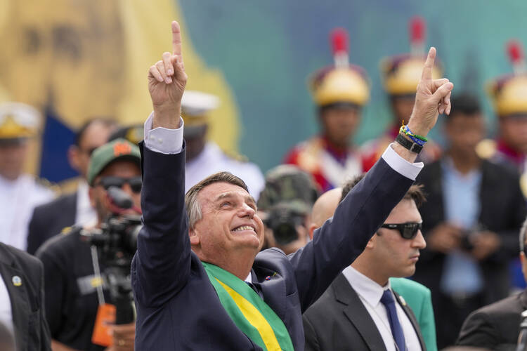 Brazil's President Jair Bolsonaro points up during a military parade to celebrate the bicentennial of the country's independence from Portugal, in Brasília, Brazil, Wednesday, Sept. 7, 2022. (AP Photo/Eraldo Peres)