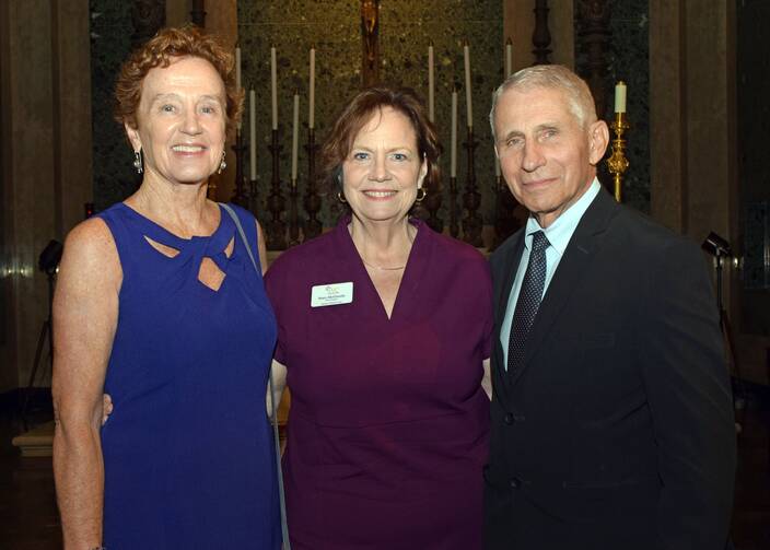 Nurse-bioethicist Christine Grady, left, and her husband, Dr. Anthony Fauci, a physician and scientist, right, are joined by Mary McGinnity, president and CEO of the Ignatian Volunteer Corps.
