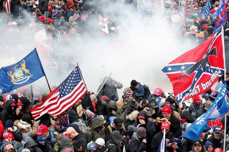 Tear gas is released into a crowd of demonstrators protesting the 2020 election results at the U.S. Capitol in Washington Jan. 6, 2021. President Donald Trump was impeached for a second time in his presidency Jan. 13, charged with "incitement of insurrection" for protesters' attack on the Capitol. (CNS photo/Shannon Stapleton, Reuters)