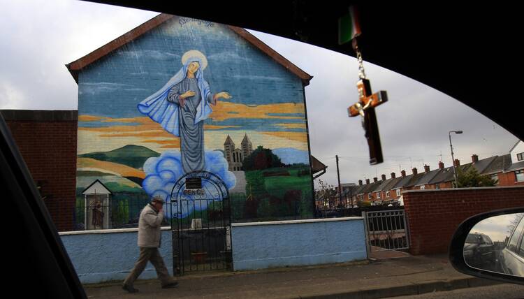 A man walks past a Marian mural in Belfast, Northern Ireland, Feb. 20, 2013. Data from the 2021 census showed 45.7% of respondents identified as Catholic or were brought up Catholic, compared with 43.5% identifying as Protestants, the first time in more than a century that Catholics outnumber Protestants. (CNS photo/Cathal McNaughton, Reuters)