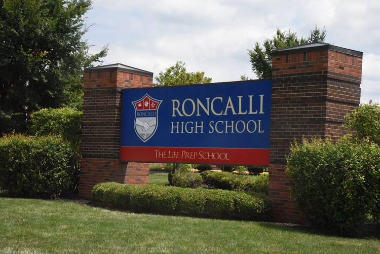 A blue sign for Roncalli High School in Indianapolis