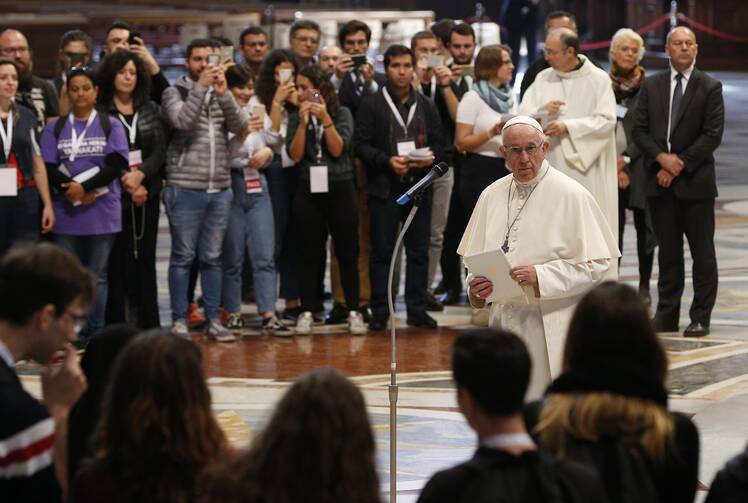 for an article on synodality, pope francis stands in front of a group of young people giving a speech