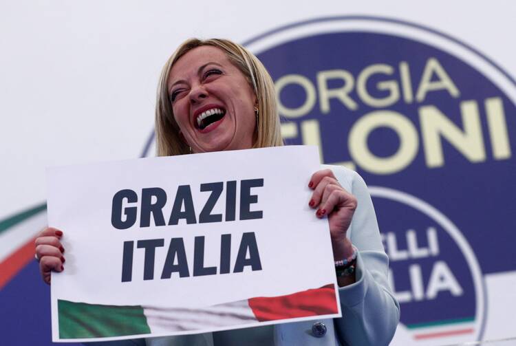 Giorgia Meloni, leader of Brothers of Italy, holds a sign at the party's election night headquarters in Rome Sept. 26, 2022. Italian voters handed a victory to a coalition of center-right parties and set the stage for Meloni to become the next prime minister. (CNS photo/Guglielmo Mangiapane, Reuters)