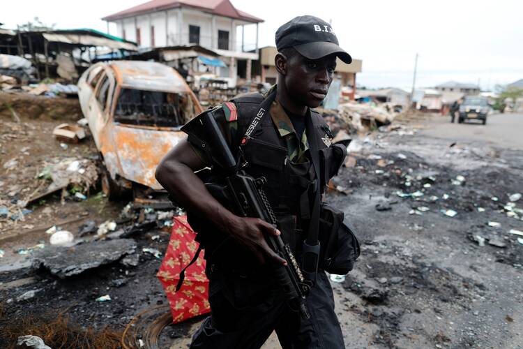 A Cameroonian elite Rapid Intervention Battalion member patrols the abandoned village of Ekona in the Anglophone region on Oct. 4, 2018. (CNS photo/Zohra Bensemra, Reuters)