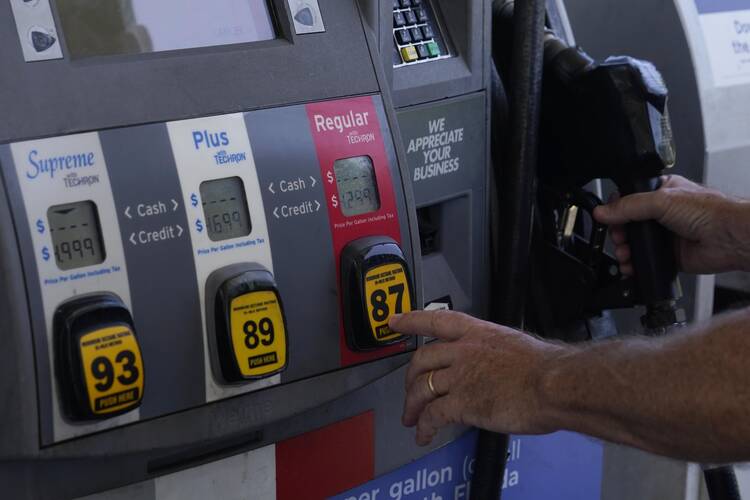 A customer pumps gas at an Exxon gas station on May 10, 2022, in Miami. (AP Photo/Marta Lavandier)