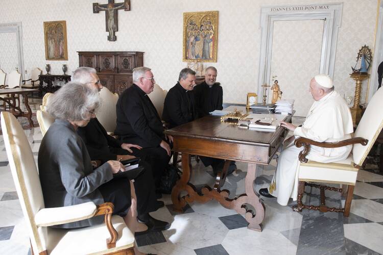 pope francis sits at a table with nathalie becquart, luis marin de san martin, jean claude hollerich, mario grech, and giacomo costa
