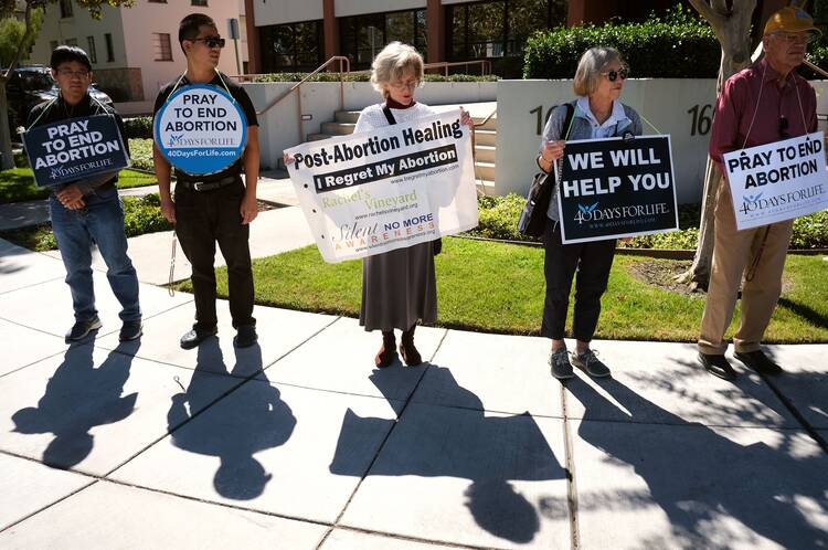 People in San Jose, Calif., participate in a recitation of the rosary outside a Planned Parenthood facility on Sept. 28, 2022. The gathering was held on the first day of the 40 Days For Life nationwide campaign, which called for peaceful protests for 40 days outside abortion facilities. (CNS photo/David Maung)