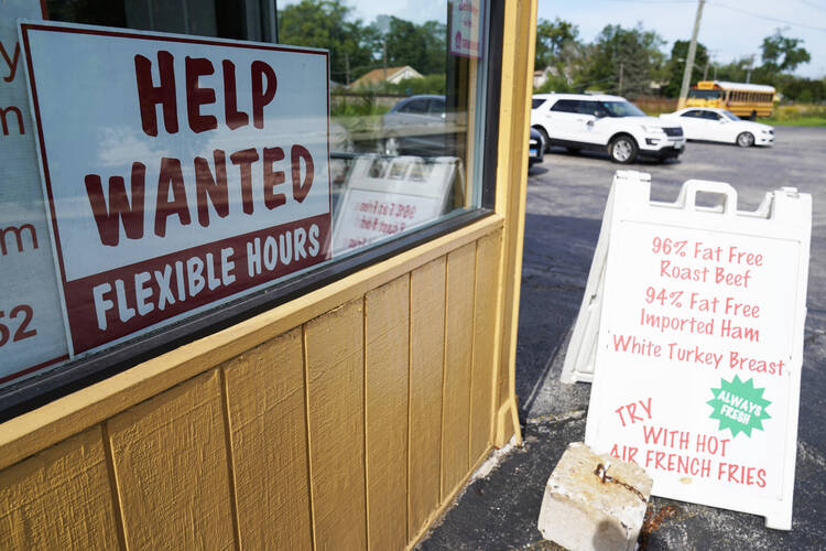 A help wanted sign is displayed in Deerfield, Ill., on Sept. 21, 2022. Interest rate hikes could bring down inflation but at the cost of job creation. (AP Photo/Nam Y. Huh, File)