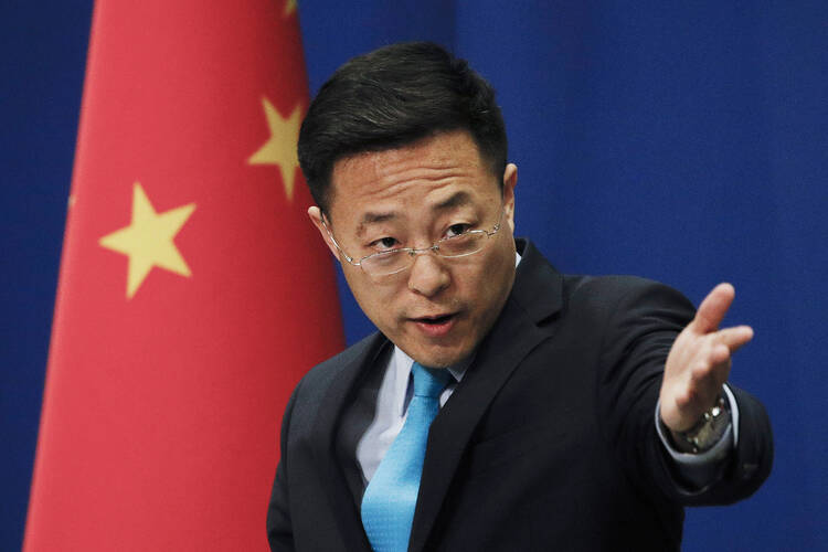 Chinese Foreign Ministry spokesperson Zhao Lijian gestures as he speaks during a daily briefing at the Ministry of Foreign Affairs office in Beijing on Feb. 24, 2020.