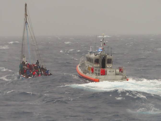 Coast Guard Station Islamorada small boat crew follows an overloaded sailing vessel off Rodriguez Key, Florida, Nov. 21, 2022. Rescue crews battled six to ten feet seas and 25 miles per hour winds to safely remove the people from the vessel. (U.S. Coast Guard photo by Lt. Robert Collins)