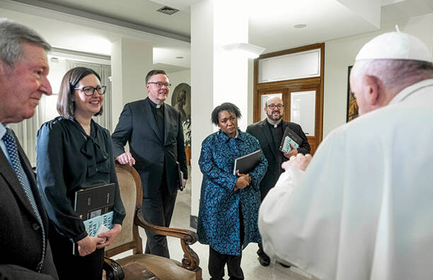 america staff stands and listens to the pope who is to the right of the camera