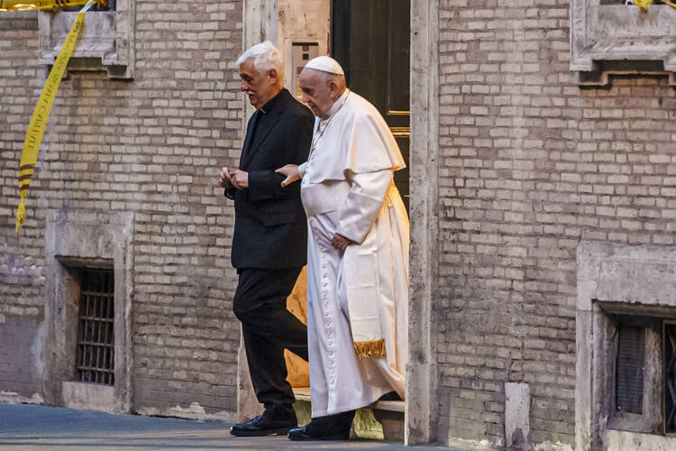 Pope Francis is flanked by Jesuits' superior general Arturo Sosa Abascal